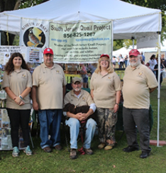 A group of South Jersey Quail Project volunteers wearing shirts embroidered with the SJQP logo